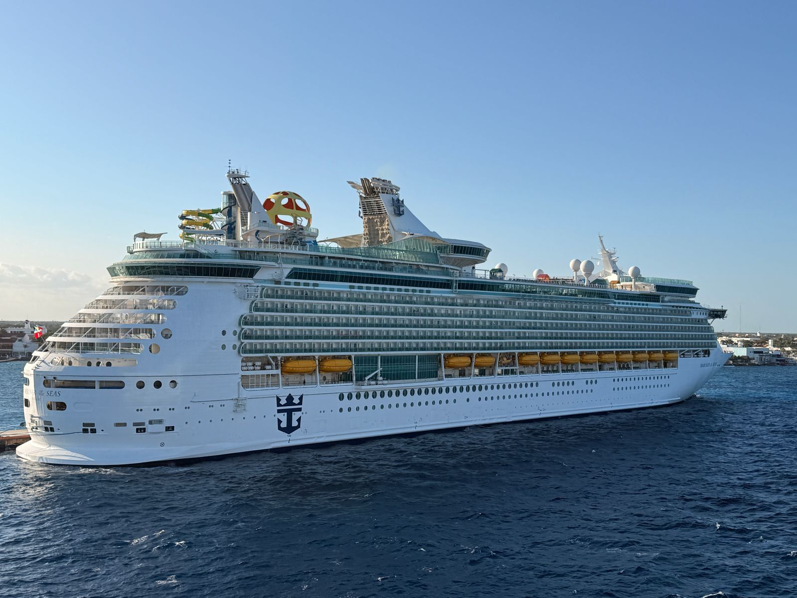 Royal Caribbean cruise ship sailing in open water under a clear sky