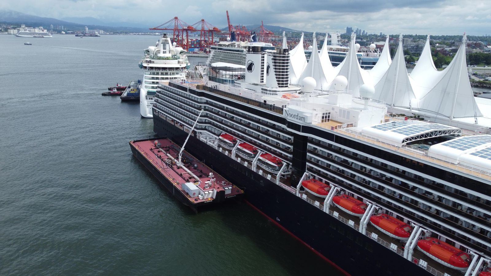 Holland America Line ship docked at Canada Place in Vancouver, beside the terminal sails