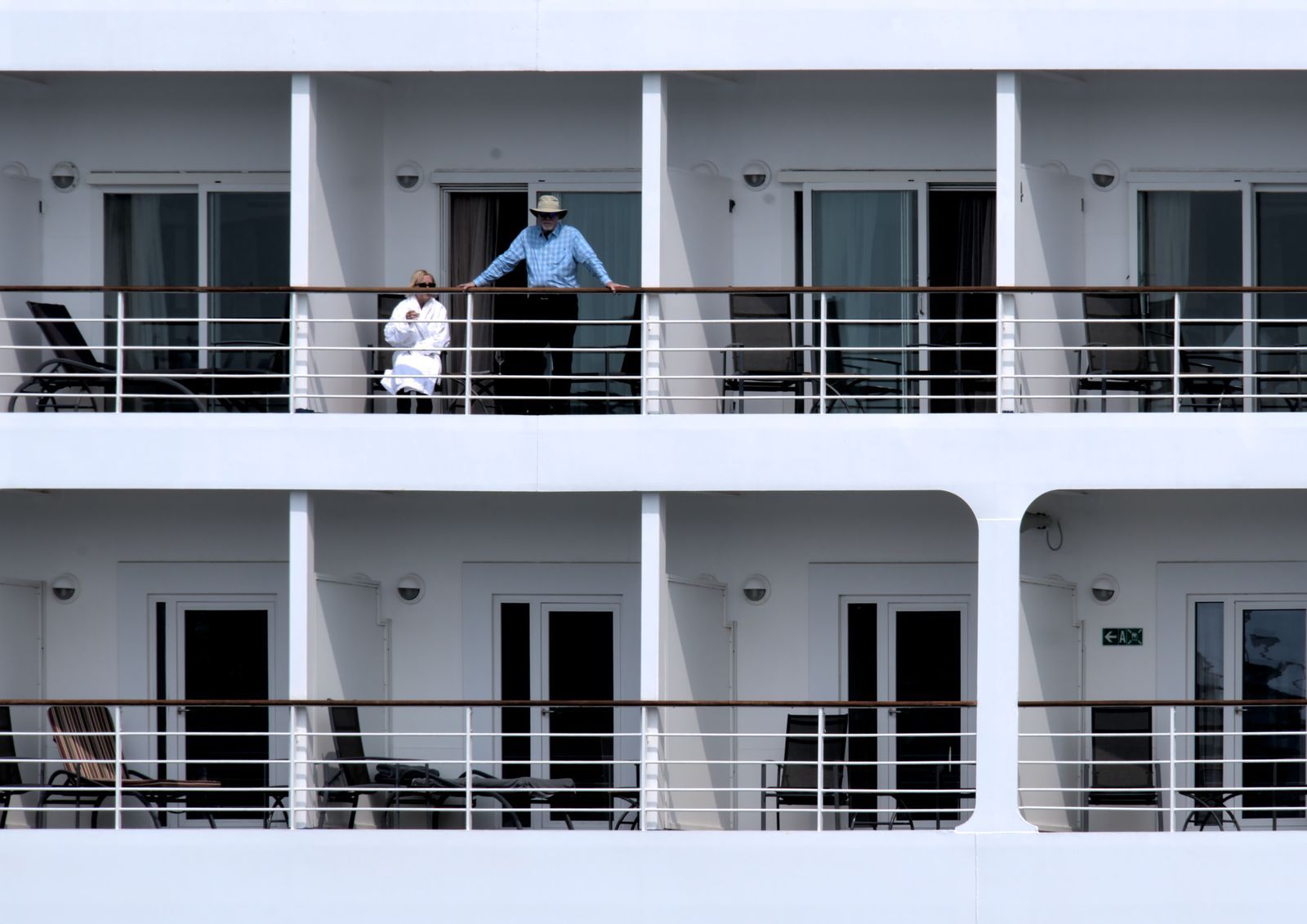 Guests on their cruise ship balconies enjoying the sea air